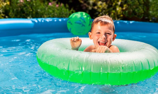 Young boy swimming in tube