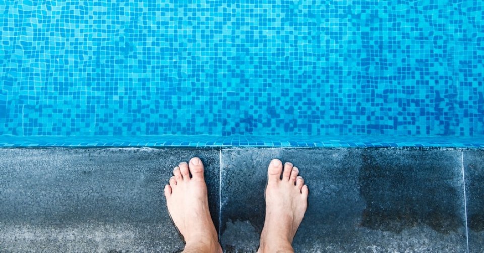 feet on edge of pool